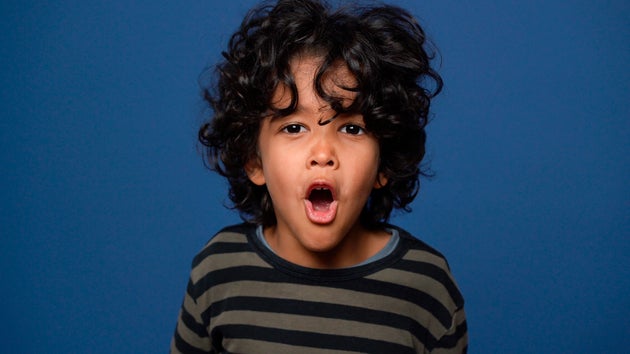 Stock image of a young boy shouting.