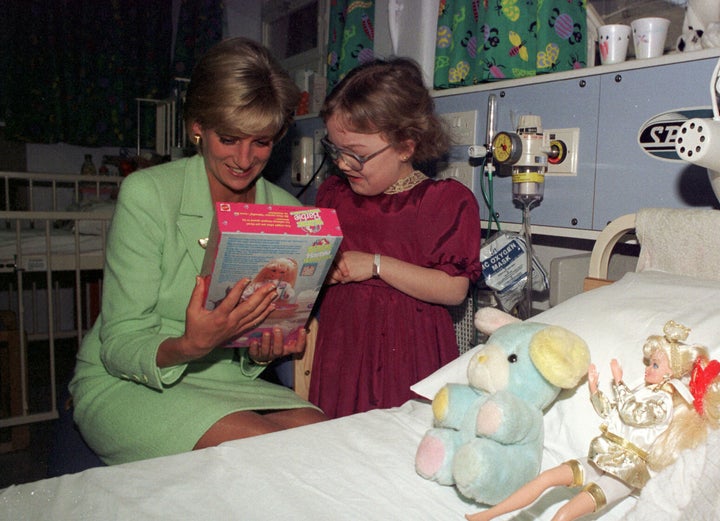 Diana, seen here visiting a young patient at the hospital in February 1997.