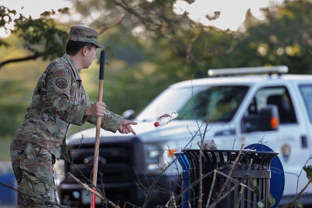 A member of the U.S. National Guard discards a bottle at the Tidal Basin near the National Mall on Tuesday in Washington.