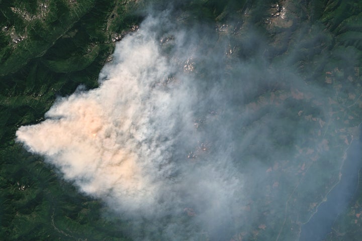A satellite view of the Bear Gulch Fire shows a dense smoke plume over Mason County, Washington, on Aug. 12, 2025, as crews battle the wildfire burning over 7,000 acres in Olympic National Forest and Park. Responders are prioritizing evacuations, air quality protection and structure defense amid challenging terrain and heavy smoke.