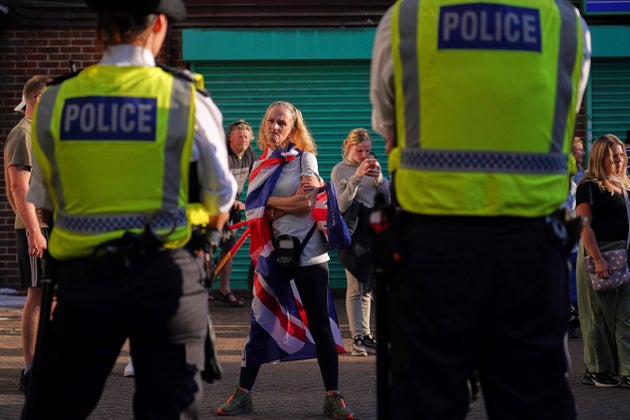 Protesters attend a demonstration in Orpington near London, Friday, Aug. 22, 2025.