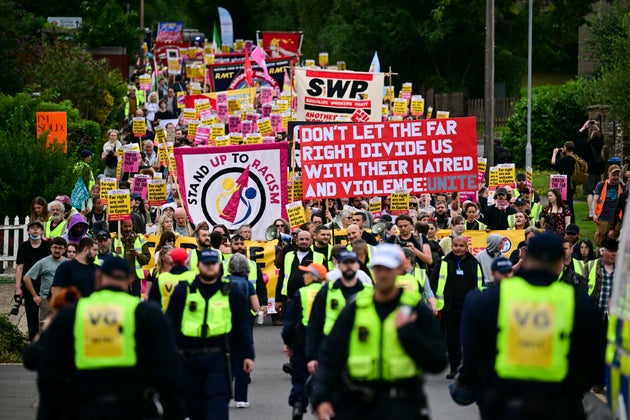 Protestors hold a banner reading