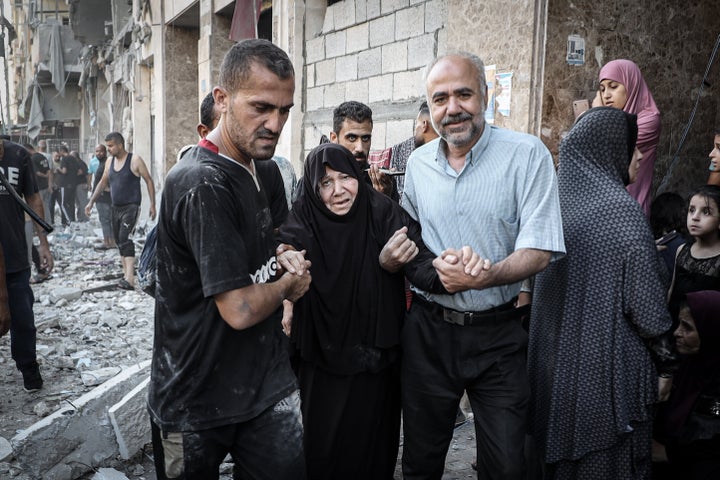 Palestinians rescue a wounded woman after an Israeli attack in Gaza City's Rimal neighborhood on Aug. 30, 2025. Civilians injured in the strike, including elderly and children, were transported to a hospital for treatment.