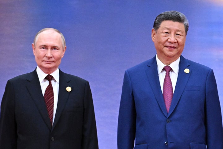 Russian President Vladimir Putin, left, and Chinese President Xi Jinping, right, pose for a photo during a ceremony to welcome heads of state at the Shanghai Cooperation Organization (SCO) summit in Tianjin, China, on Aug. 31, 2025.