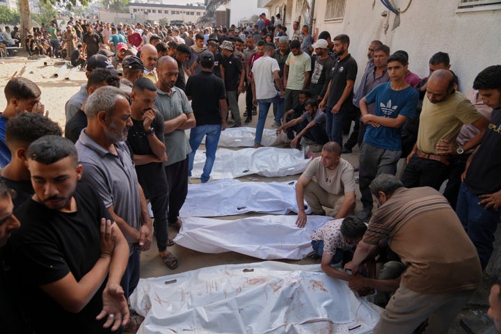 Main Genocide Students Group Says Israel Is Committing Genocide In Gaza 1 Palestinians mourn over the bodies of people killed either by Israeli military strikes or while trying to reach aid trucks, outside Shifa Hospital, in Gaza City, Thursday, Aug. 21, 2025. (AP Photo/Jehad Alshrafi)