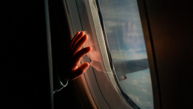 Closeup of child's hand on a plane