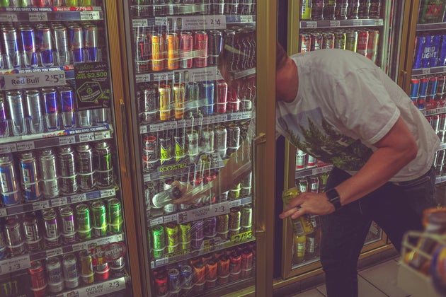 Man going through energy drink aisle