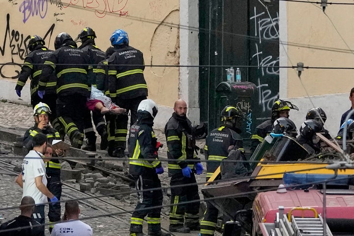 Iconic Lisbon Streetcar Derails, Killing 15 Individuals 2 Firefighters carrying the body of a person on a stretcher at the site of a derailed electric streetcar in Lisbon, Portugal, Wednesday, Sept. 3, 2025.