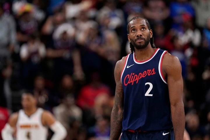 Los Angeles Clippers forward Kawhi Leonard, right, looks toward the scoreboard during the second half of an NBA basketball game, May 1, 2025, in Inglewood, California.