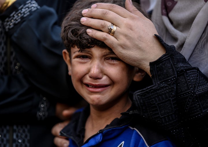 A Palestinian boy cries as the bodies of more than 45 people killed in Israeli army attacks are laid to rest by their families at Al-Shifa Hospital's morgue, in Gaza City on Sept. 7, 2025.