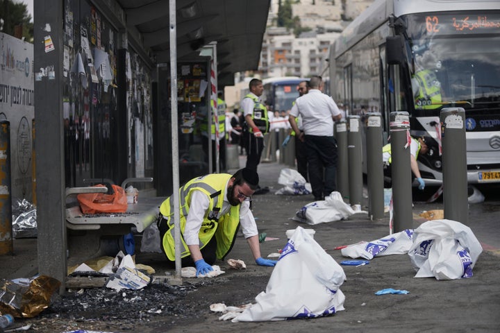 Israeli ZAKA rescue and recovery personnel clean bloodstains at the scene of a shooting attack carried out by two Palestinian gunmen, in which several people were killed and others injured at a bus stop in Jerusalem, on Sept. 8, 2025.