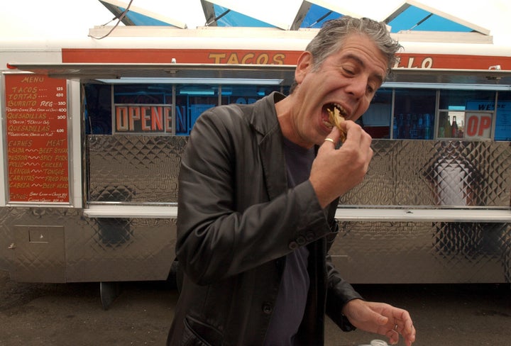 Bourdain eats a carne asada taco from a food truck in Oakland, California, during an episode of "No Reservations" in 2007.