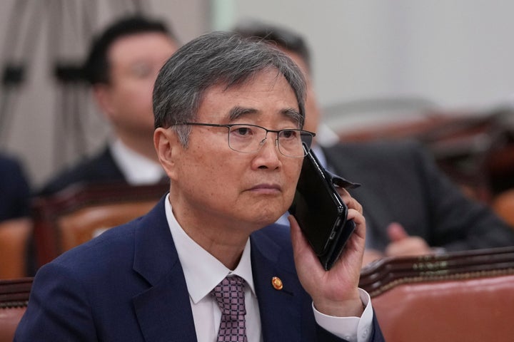 South Korean Foreign Minister Cho Hyun holds his mobile phone before a session of the Foreign Affairs and Unification Committee at the National Assembly in Seoul, South Korea, on Sept. 8, 2025.