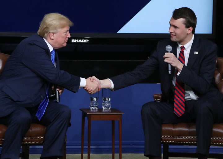 U.S. President Donald Trump shakes hands with conservative activist Charlie Kirk at a forum dubbed the Generation Next Summit at the White House on March 22, 2018, in Washington, D.C. 