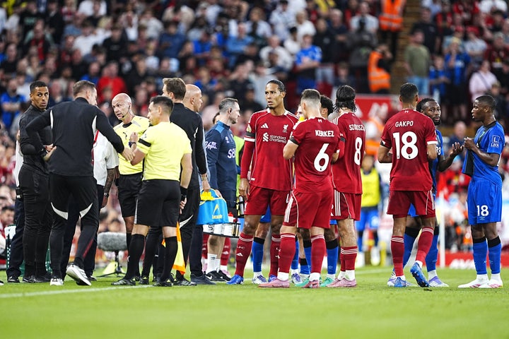 Liverpool players during a stop in play after Bournemouth's Antoine Semenyo, second right, informs referee Anthony Taylor, third left, of a possible racial comment from the crowd during the Premier League match at Anfield, Liverpool, in August 2025.