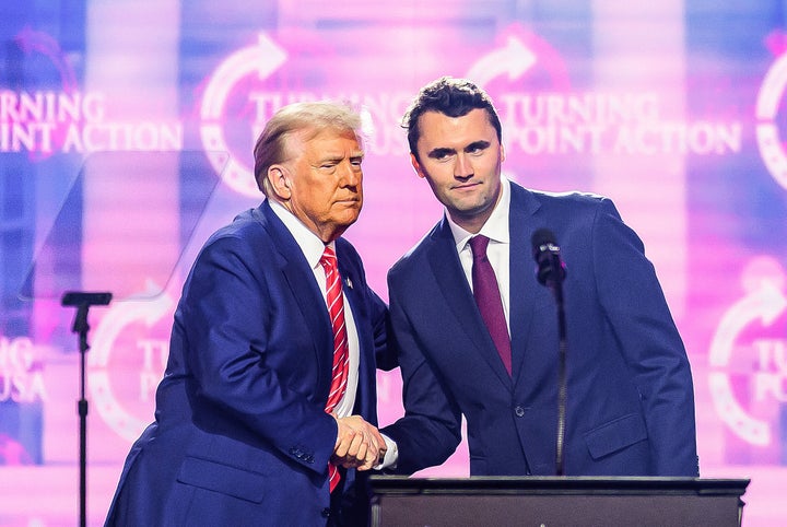 Charlie Kirk speaks on stage with President Donald Trump at America Fest 2024 in Phoenix, Arizona, on December 22, 2024.