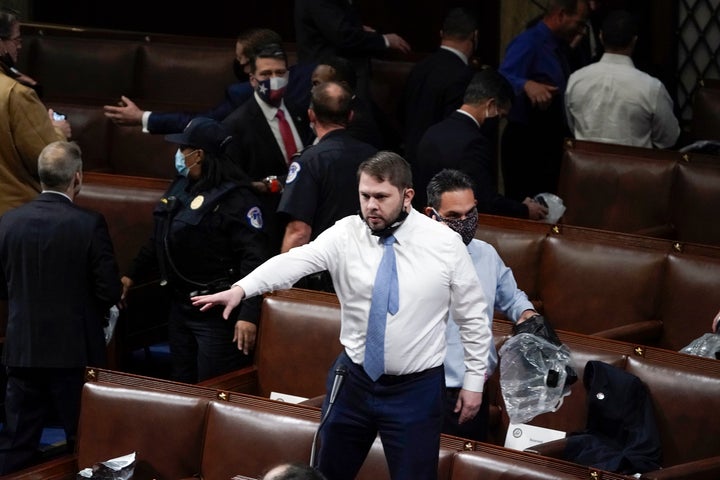 Then-Rep. Ruben Gallego (D-Ariz.) stands on a chair as lawmakers prepare to evacuate the floor as rioters try to break into the House Chamber at the U.S. Capitol on Wednesday, Jan. 6, 2021, in Washington.