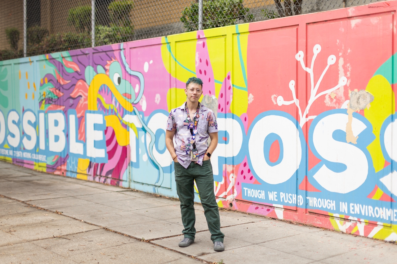 Skye Tooley, an elementary school teacher in East Hollywood and a UTLA member, is pictured outside the school where they work on Sept. 11, 2025. Tooley said they do a few loops around the school and nearby neighborhood before starting work to scan for any ICE activity in the area, and that more teachers have also expressed interest in joining them.