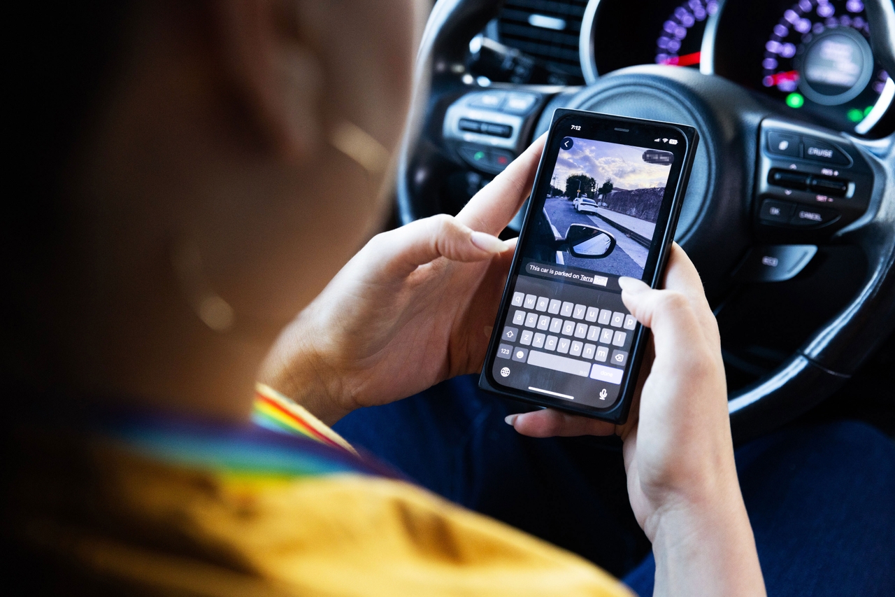 Elementary school psychologist Clemen Avalos sends a photo of a suspicious car to a group chat as she patrols for ICE activity on Sept. 10, 2025.