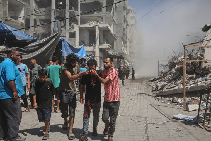 Palestinians evacuate a man who was injured in an Israeli military strike on a building in Gaza City, Saturday, Sept. 13, 2025. (AP Photo/Yousef Al Zanoun)