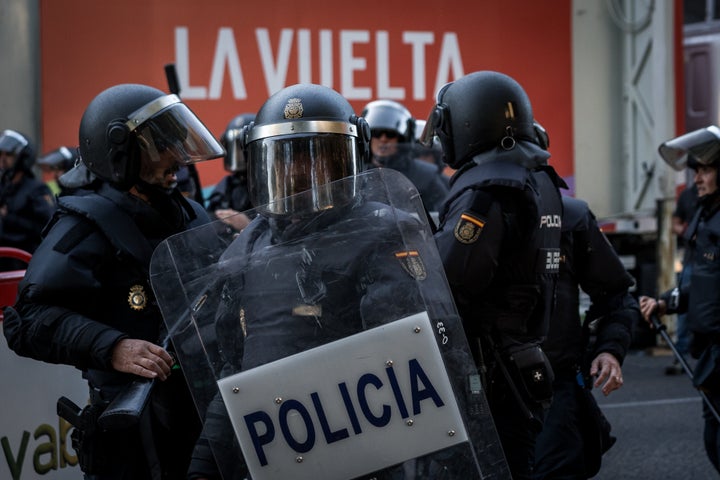Riot police clash with pro-Palestinian demonstrators disrupting the final stage of La Vuelta cycling race on Sept. 14, 2025, in Madrid, Spain. Protesters blocked key sections of the city center to oppose the participation of the Israel Premier Tech team, denouncing Israel's actions in Gaza and the West Bank.