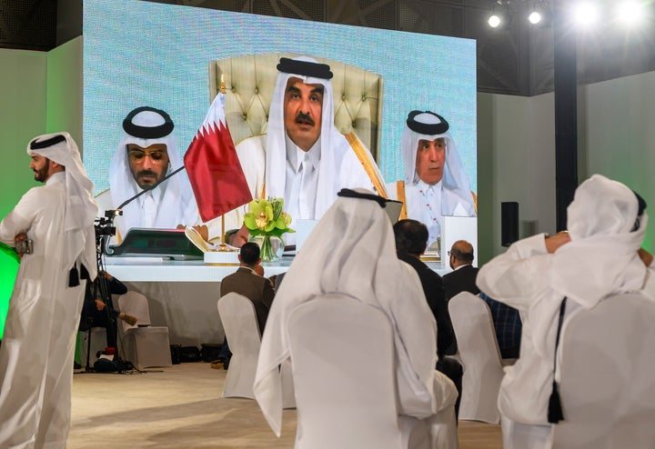 Journalists watch Qatar's ruling emir, Sheikh Tamim bin Hamad Al Thani, deliver the opening speech for an Arab-Islamic summit to discuss the Israeli attack on Hamas in the Gulf country's capital of Doha, on Sept. 15, 2025.