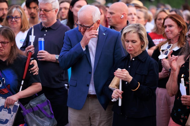 Minnesota Gov. Tim Walz and his wife Gwen Walz attend a candlelight vigil for former House Speaker Melissa Hortman and her husband Mark, who were fatally shot, at the state Capitol on June 18 in St. Paul, Minnesota.