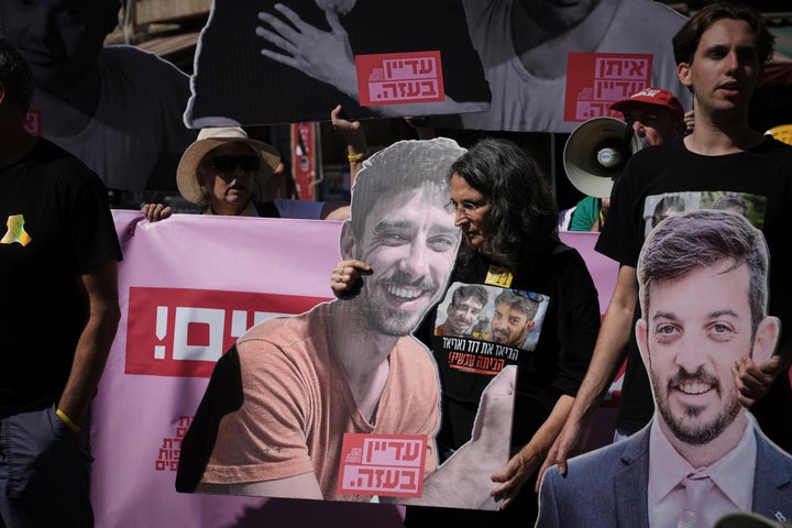 Israel's Navy Says Its Expanded Operation In Gaza Metropolis Has Begun 3 Demonstrators hold photos depicting the faces of Israeli hostages who are being held in the Gaza Strip, during a protest demanding their release from Hamas captivity and against the Israeli offensive in Gaza City, in Jerusalem, on Sept. 16, 2025.