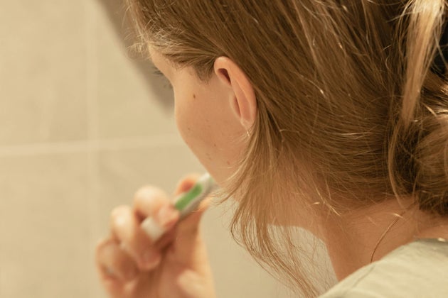 Woman brushing teeth