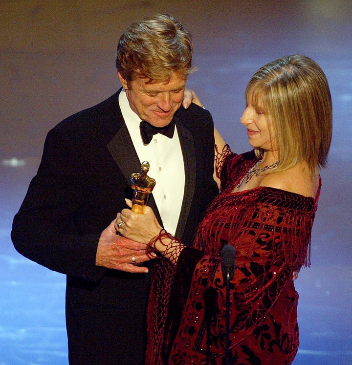 Barbra Streisand hands Redford his Oscar for his four decades of screenwork and his support to independent filmmaking, during the 74th Academy Awards at the Kodak Theater in Hollywood in March 2002.