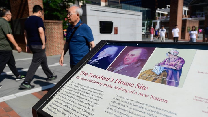 Tourists walk past a plaque near the Liberty Bell that discusses the Founding Fathers and their link to slavery in Philadelphia, Pennsylvania. Exhibits and displays in Independence National Park are under review by the National Park Service in an initiative to eliminate materials deemed disparaging to the Founding Fathers or the legacy of the United States is part of an executive order issued by Donald Trump in March. 