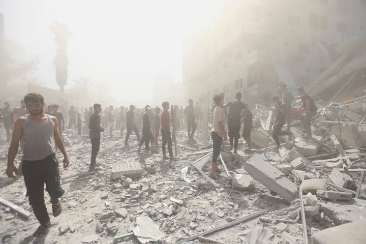 Palestinians inspect the rubble of a building from which thousands of artifacts were removed before being destroyed in an Israeli military strike in Gaza City, on Sept. 14, 2025.