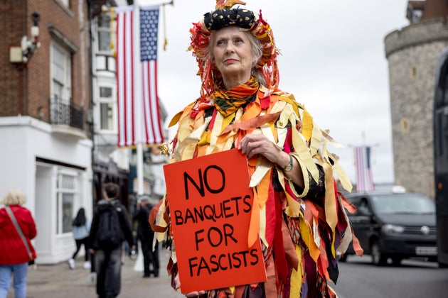 A protester holds up a placard during the state visit by the President of the United States of America outside Windsor Castle on September 17, 2025 in Windsor, England.