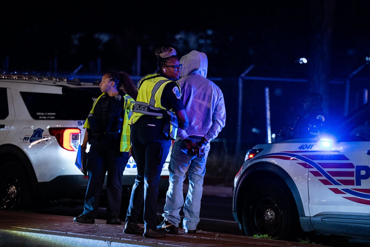 Metropolitan Police Department officers detain a driver during a traffic stop at a checkpoint in the Ivy City neighborhood of Washington, D.C., in August. President Donald Trump threatened that prosecutors would seek the death penalty for anyone found guilty of murder in the district, a move that would escalate his crime crackdown in the nation's capital.