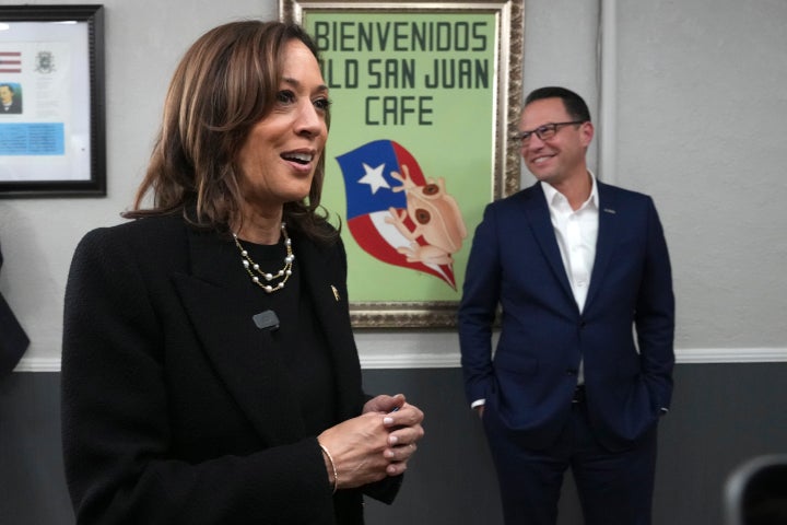 From Left: Democratic presidential nominee Vice President Kamala Harris, left, visits Old San Juan Cafe as Pennsylvania Gov. Josh Shapiro looks on during a campaign stop in Reading, Pa., on Nov. 4, 2024.