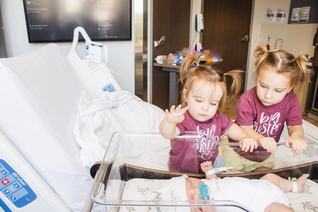 The author's two daughters visiting their newest sibling at the hospital.