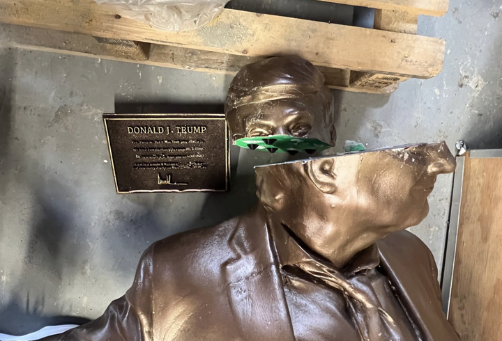 A statue of President Donald Trump and sex offender Jeffrey Epstein holding hands lies broken after it was installed on the National Mall by a group known as The Secret Handshake.