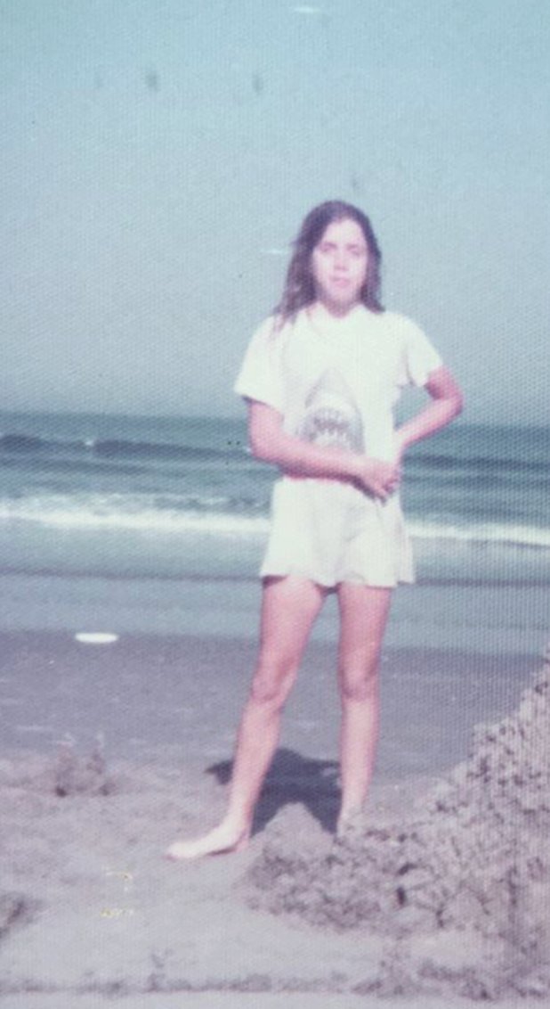 The author, a few weeks after the incident, building a sandcastle at the Jersey Shore in her favorite "Jaws" T-shirt.