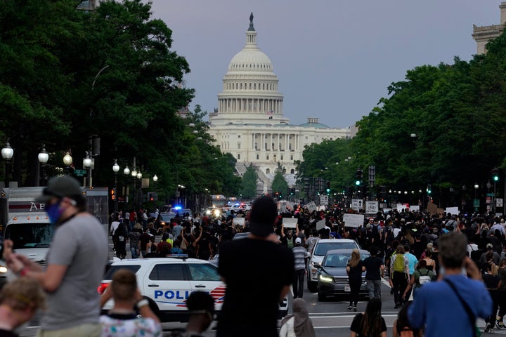 FILE - Demonstrators walk along Pennsylvania Avenue as they protest the death of George Floyd, May 29, 2020, in Washington. (AP Photo/Evan Vucci, File)