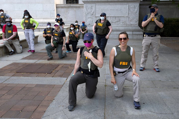 Report: FBI Fires Brokers Photographed Kneeling At 2020 Racial Justice Protest 1 FILE - Federal Bureau of Investigation (FBI) officers take a knee with demonstrators, as they march on Pennsylvania Ave, June 4, 2020, in Washington, during a protest over the death of George Floyd, an unarmed black man, who died after a police officer kneeled on his neck for several minutes. (AP Photo/Jose Luis Magana, File)