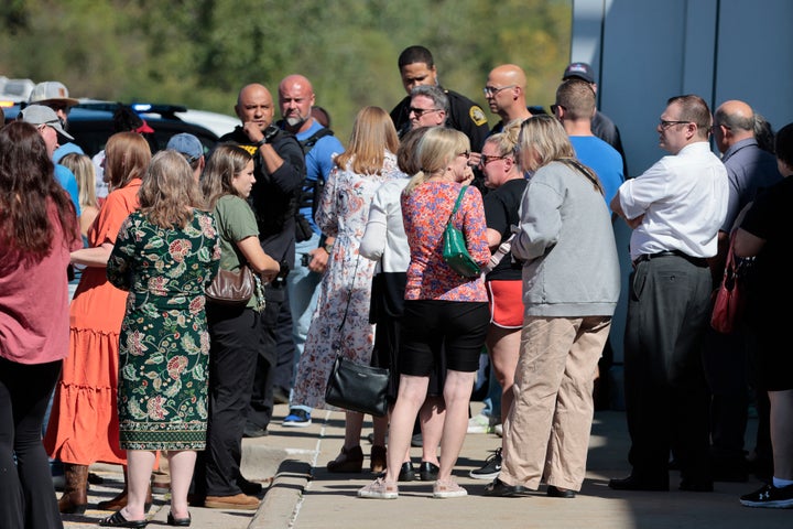 People gather near the scene of a shooting at a Mormon church in Grand Blanc, Michigan, on Sept. 28, 2025. Police say a 40-year-old man killed at least one person and injured several others after ramming a pickup truck into the church, opening fire on the hundreds of people attending Sunday services and setting the church ablaze. Officers fatally shot the suspect.