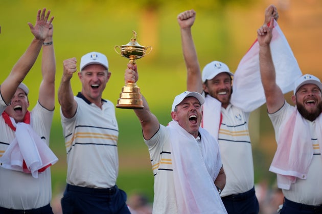 Europe's Rory McIlroy poses with the trophy after winning the Ryder Cup golf tournament against the United States on the Bethpage Black golf course.