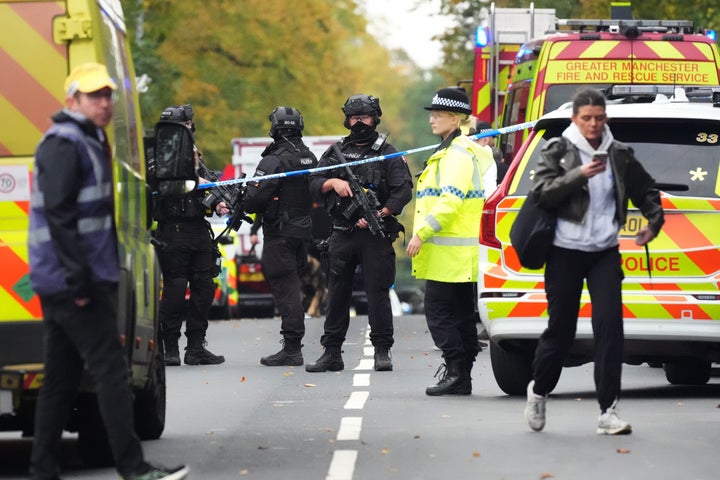 Armed Police, emergency responders and congregants gather near the Heaton Park Hebrew Congregation Synagogue, where multiple were injured after stabbing and car attack on Yom Kippur, on October 2, 2025 in the Crumpsall suburb of Manchester, England. (Photo by Christopher Furlong/Getty Images)