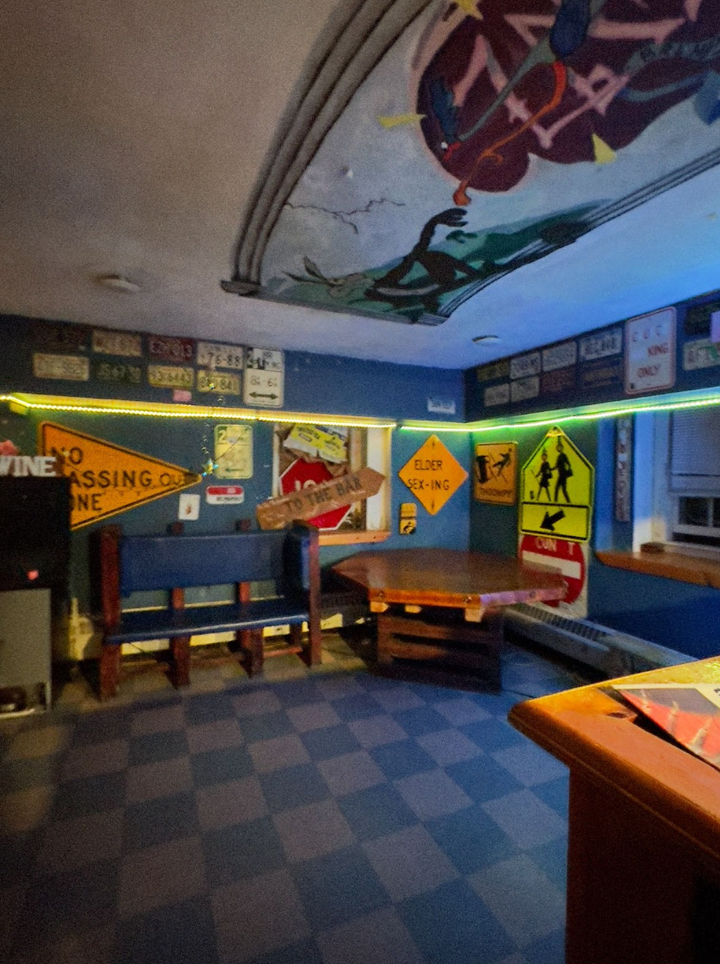 Some of the signs along the bar inside the fraternity house where the author lived.