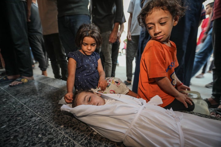 Rubio Says Gaza Offensive Is not Over But, As Israel Retains Pounding Determined Palestinians 1 (EDITOR'S NOTE: Image depicts death) Palestinian children at al-Ahli Hospital look over the shrouded body of a boy who was killed in an Israeli attack on Gaza City's al-Tuffah neighborhood, on Oct. 4, 2025.