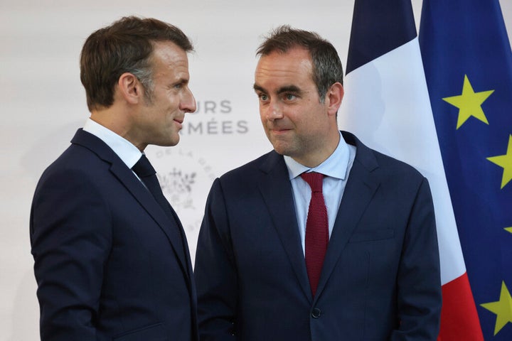 Then French Defense minister Sebastien Lecornu, right, and France's President Emmanuel Macron talk at the end of an address by the president to army leaders in Paris on July 13, 2025.
