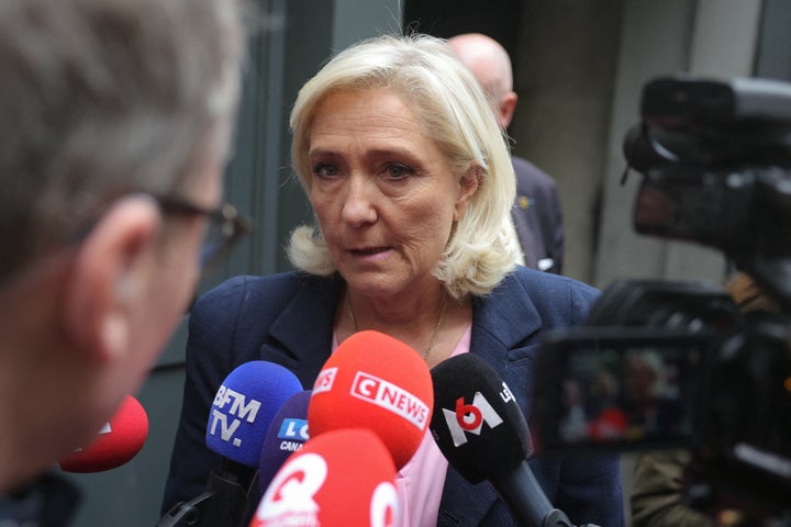 The president of Rassemblement National parliamentary group Marine Le Pen addresses the press upon her arrival at her party's headquarters in Paris, on Oct. 6, 2025. 