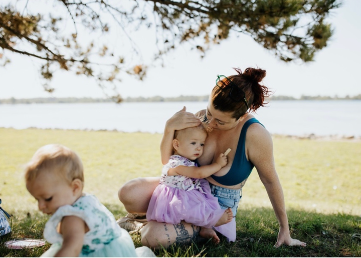 The author holding 1-year-old Arden, with Miko in the foreground by the Detroit River.