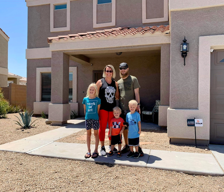 The author and her family in front of their house before they sold it in 2019.