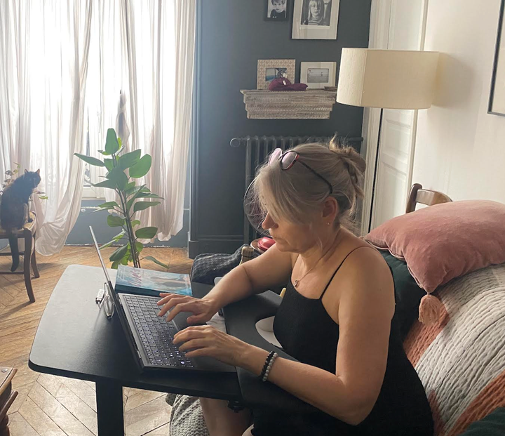 The author writing at home.